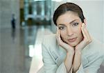 Woman cupping head in hands