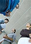 Group of young business people speaking, low angle view