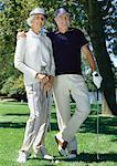 Mature couple playing golf