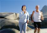 Mature couple running on beach