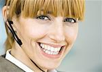 Woman wearing headset, smiling