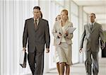 Executives walking through corridor of office building