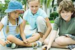 Children playing marbles in residential street