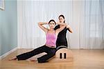 Woman Exercising with Trainer