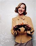 Woman Holding Tray of Sausages