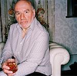 Portrait of Man with Drink on Sofa