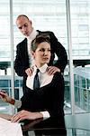 Businessman Rubbing Businesswoman's Shoulders