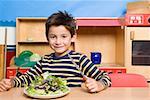 Boy with a plate of salad