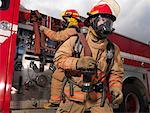 Firefighters Pulling Fire Hose from Fire Truck