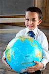 Boy in Schoolhouse with Globe