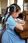 Girl Writing in Classroom