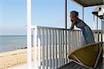 Woman Leaning on Porch Railing