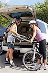 Couple Loading Bikes into Vehicle