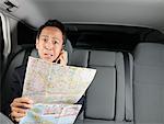 Businessman Looking at Map in Car