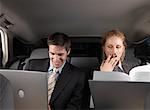 Businesspeople Working in Back of Car