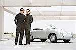 Couple Standing in Front of Porsche Speedster