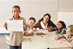 Students and Teacher with Drawings in Classroom