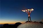 Circus Performer Holding Fire Wheel Above Head