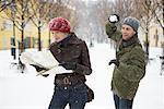 Man Sneaking up on Woman with Snowball