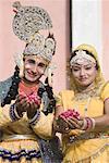 Portrait of two performers holding rose petals at an elephant festival, Jaipur, Rajasthan, India