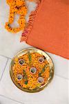High angle view of oil lamps with petals of Marigolds on a plate