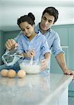 Father and daughter cooking together