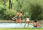 Father playing with children in swimming pool
