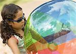 Girl holding beach ball