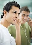 Teen males listening to earphones