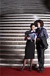 Couple Looking at Brochure in Hotel Lobby