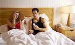 Couple in Bed, Woman Taking Pills