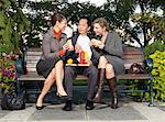 People Eating Lunch on Park Bench