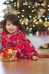 Little Girl Playing with Toy Train on Christmas Morning