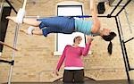 Woman Exercising With Pilates Instructor