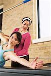 Woman Exercising With Pilates Instructor