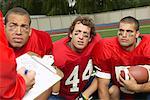 Coach Talking to Football Players in Huddle