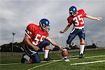 Football Player Kicking Football