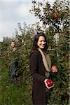 Couple Picking Apples in Orchard