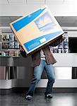 Man Carrying Large Television Box