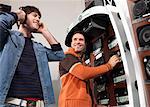 Zwei Männer anhören Stereoanlagen im Elektronik-Shop