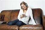 Woman on Sofa, Listening to Music