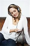 Woman on Sofa, Listening to Music