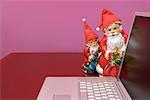 Santa Figurines and Laptop