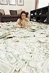 Woman at Home with Pile of Money