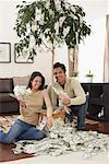 Couple at Home with Money Tree