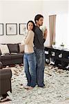 Couple at Home with Pile of Money