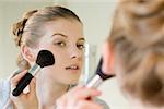 Woman applying face powder