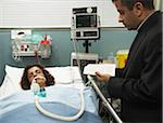 Priest Reading Last Rites to Hospital Patient