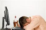 Businessman Passed out at Computer after Drinking