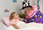 Clown Examining Child in Hospital Bed